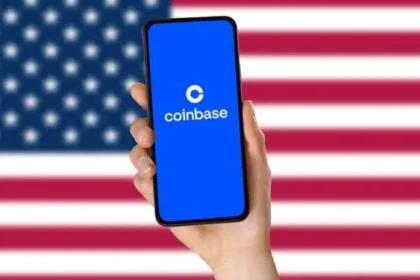 Logo de Coinbase en un smartphone frente a la bandera de Estados Unidos.